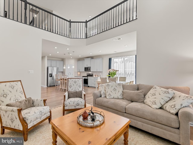 37268 Brenda Ln, Frankford, DE 19945 - living area with light wood-style floors, a towering ceiling, and visible vents