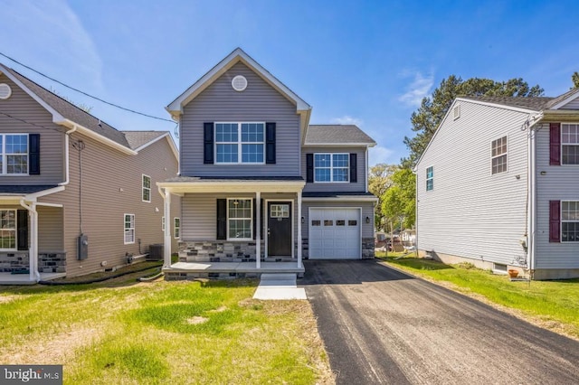 traditional-style house with driveway, cooling unit, covered porch, a front lawn, and a garage