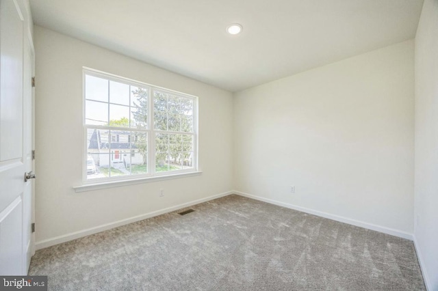 empty room with visible vents, baseboards, recessed lighting, and carpet floors