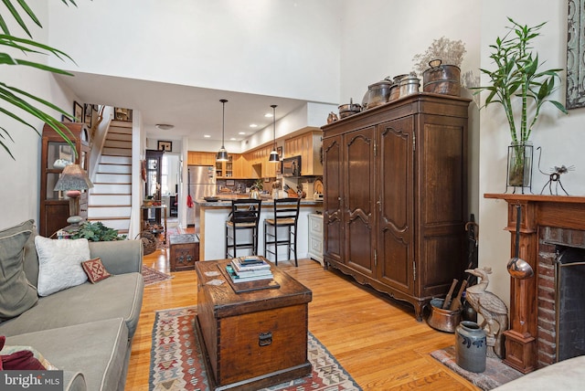 400 S 2nd St Unit 408B, Philadelphia, PA 19147 - living room with a high ceiling, light wood finished floors, a brick fireplace, recessed lighting, and stairway