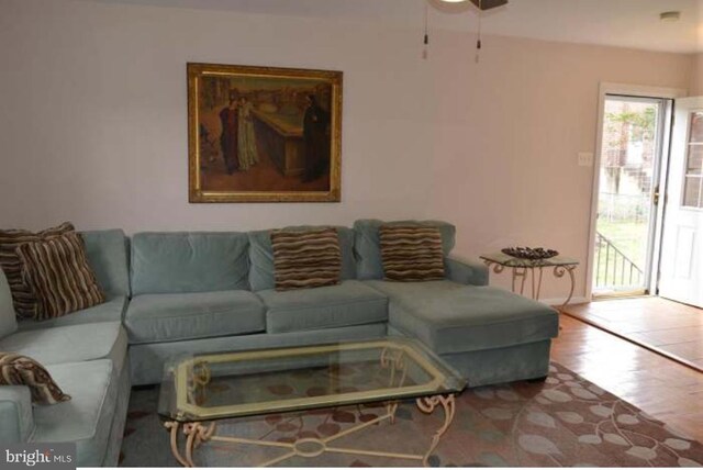 living area featuring wood finished floors and a ceiling fan