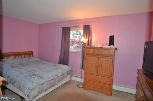 bedroom featuring light colored carpet and baseboards