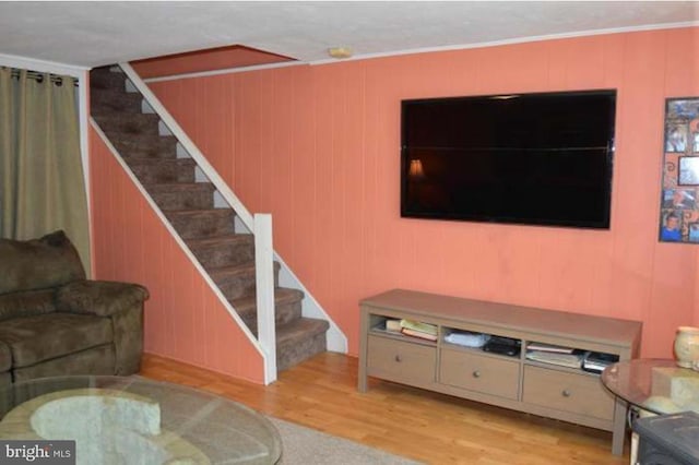 living area featuring stairway and light wood-style floors