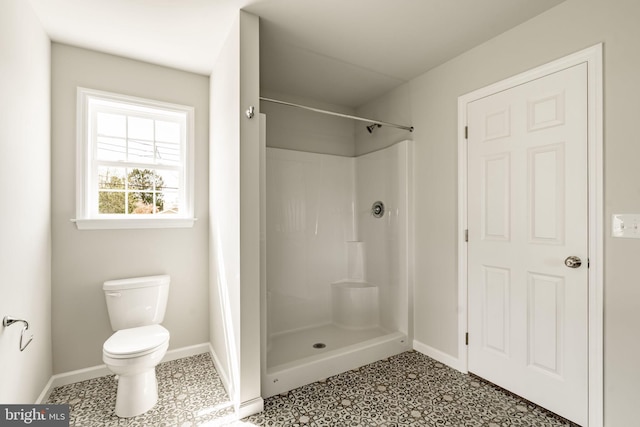 full bath featuring a shower, toilet, tile patterned floors, and baseboards