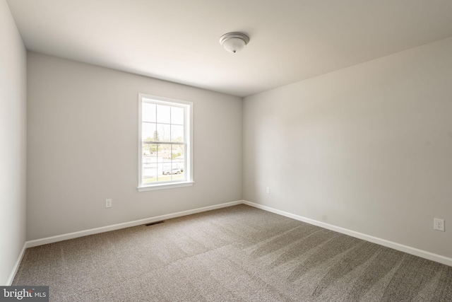 carpeted empty room with baseboards