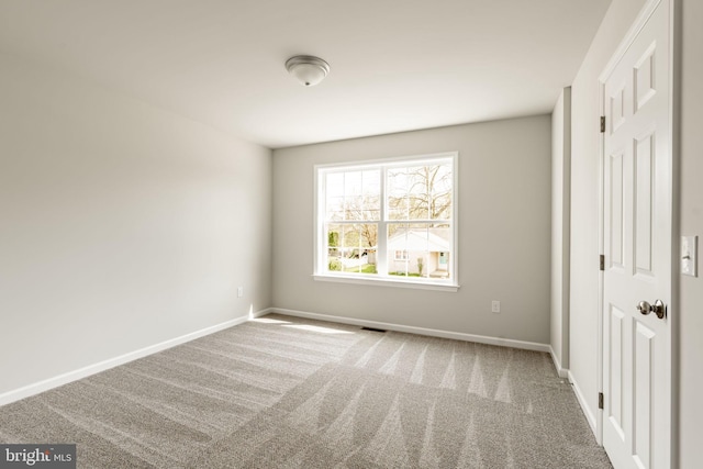 unfurnished bedroom featuring baseboards, visible vents, and carpet floors