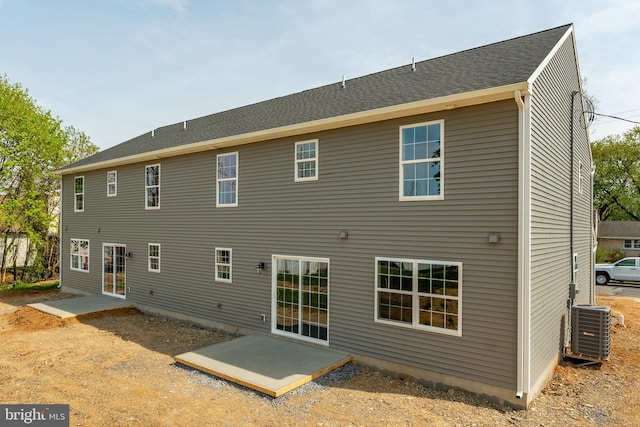 rear view of property featuring central AC and a patio