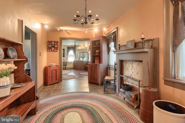 interior space featuring tile patterned flooring and a chandelier