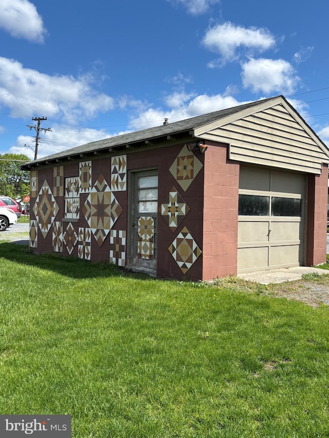 exterior space with a lawn and an outbuilding