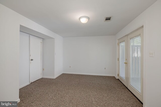 carpeted empty room with visible vents and baseboards