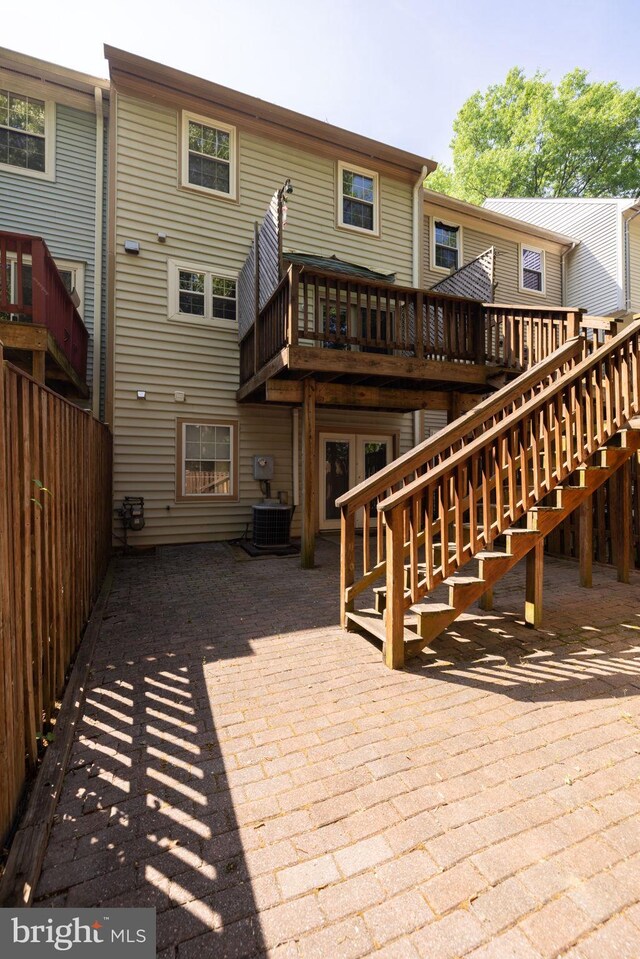 back of house featuring a patio area, central air condition unit, a wooden deck, and fence