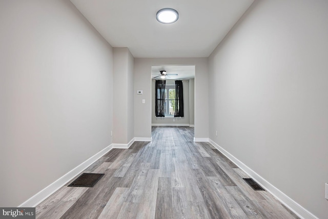 3302 W Belvedere Ave, Baltimore, MD 21215 - corridor featuring baseboards, visible vents, and wood finished floors