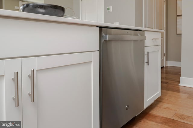 details featuring white cabinetry, light countertops, baseboards, light wood-type flooring, and dishwasher