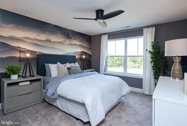 bedroom featuring light colored carpet, visible vents, ceiling fan, and baseboards