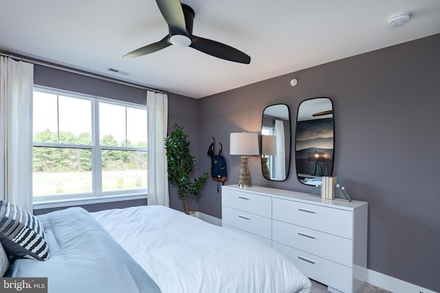 bedroom with a ceiling fan, visible vents, and baseboards