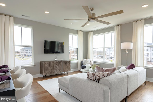 living area with visible vents, recessed lighting, and light wood-style flooring