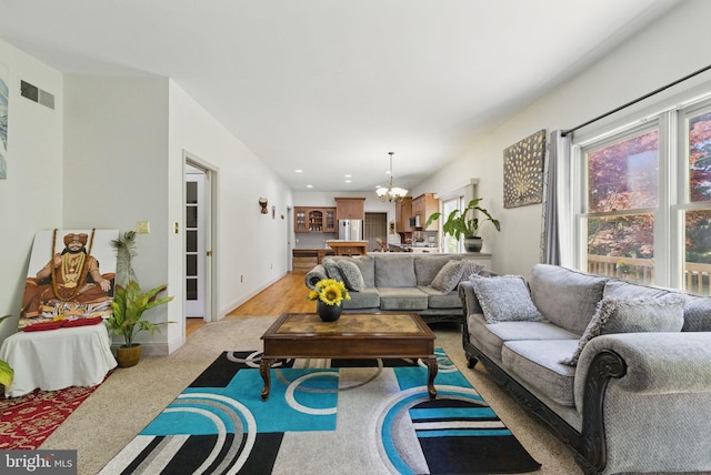 living room featuring visible vents, recessed lighting, and a chandelier