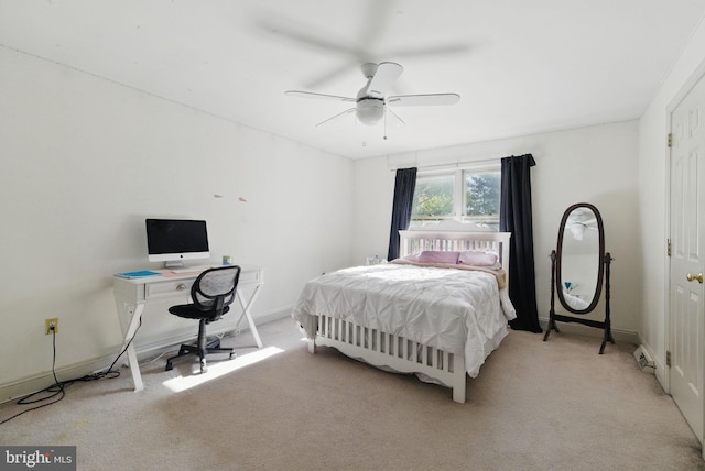 bedroom featuring a ceiling fan, baseboards, and light colored carpet