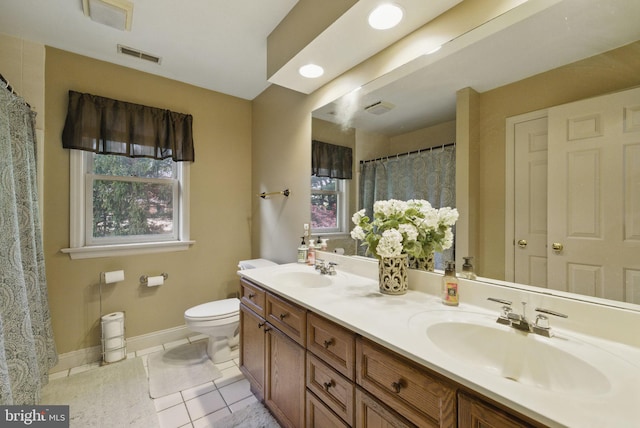 bathroom with a sink, plenty of natural light, and visible vents