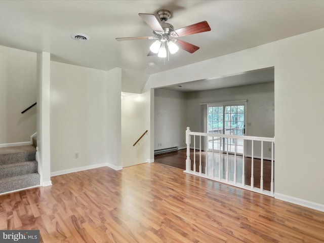 321 Valley View Dr, Waynesboro, PA 17268 - spare room featuring a baseboard heating unit, wood finished floors, a ceiling fan, and baseboards