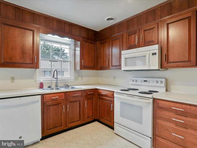 321 Valley View Dr, Waynesboro, PA 17268 - kitchen featuring white appliances, a sink, light countertops, brown cabinetry, and light floors