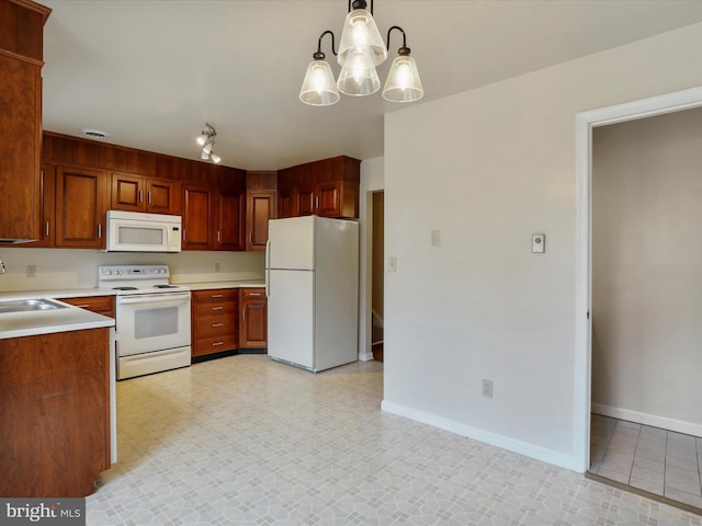 321 Valley View Dr, Waynesboro, PA 17268 - kitchen featuring white appliances, baseboards, light countertops, a chandelier, and track lighting