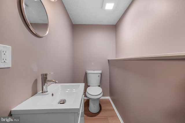 2909 Golden Fleece Dr, Pasadena, MD 21122 - bathroom with toilet, wood finished floors, vanity, and baseboards