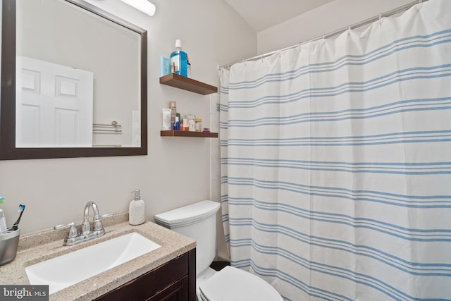 bathroom featuring toilet, a shower with shower curtain, and vanity