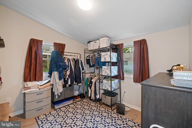 spacious closet featuring wood finished floors and vaulted ceiling