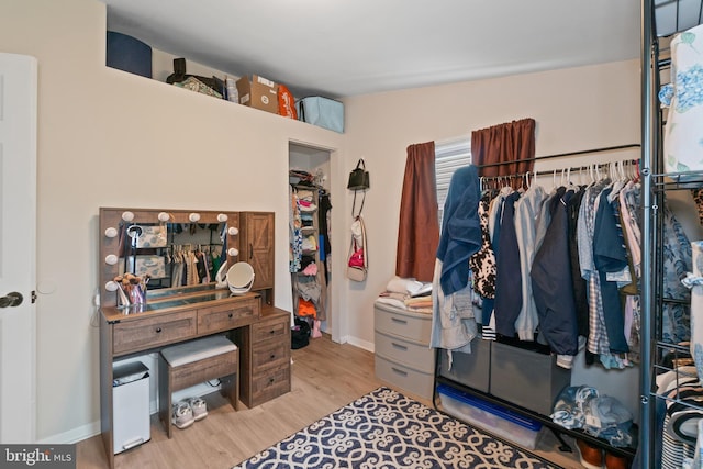 walk in closet featuring wood finished floors