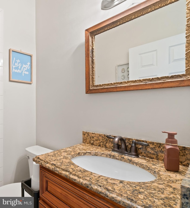 bathroom featuring toilet and vanity