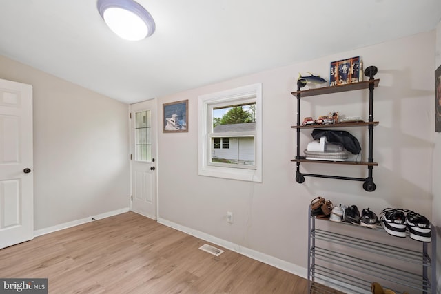 entrance foyer with light wood-type flooring, baseboards, and visible vents