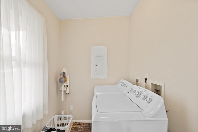 clothes washing area with electric panel, laundry area, and washing machine and clothes dryer