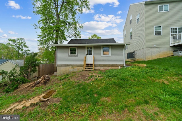 back of house featuring fence, central AC unit, and entry steps