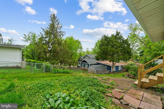 view of yard featuring fence and a gate