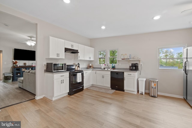 kitchen featuring white cabinets, a ceiling fan, light wood finished floors, and black appliances