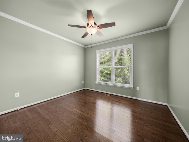 empty room with wood finished floors, crown molding, a ceiling fan, and baseboards