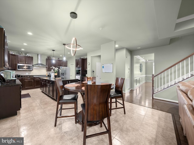 dining space featuring recessed lighting, light tile patterned floors, and stairs