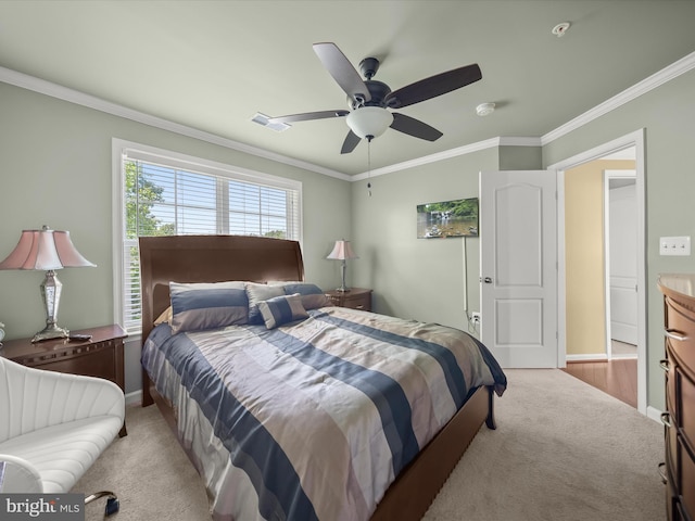 carpeted bedroom with crown molding, baseboards, and a ceiling fan