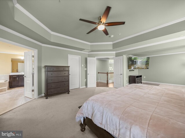 bedroom featuring crown molding, baseboards, a tray ceiling, and light colored carpet