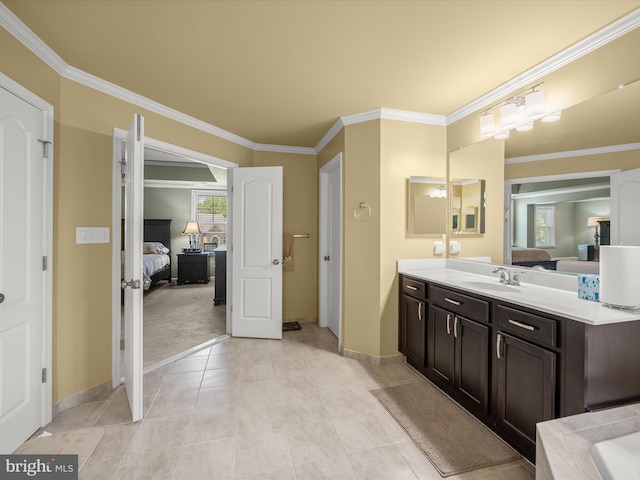 ensuite bathroom with crown molding, baseboards, vanity, and tile patterned flooring