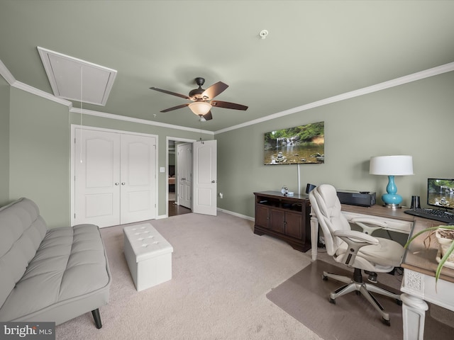office space with attic access, carpet flooring, crown molding, a ceiling fan, and baseboards