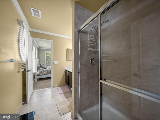 ensuite bathroom featuring ornamental molding, a shower stall, baseboards, tile patterned floors, and vanity