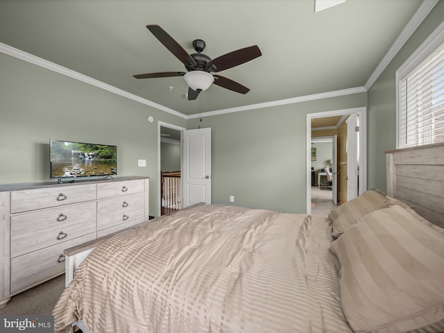 carpeted bedroom featuring ornamental molding and a ceiling fan