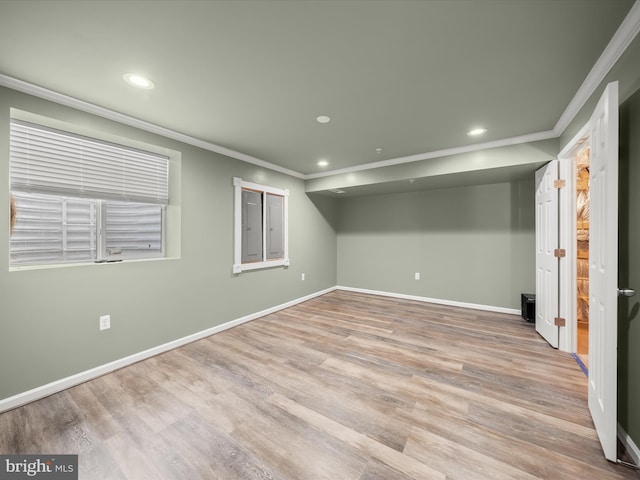 basement with ornamental molding, recessed lighting, baseboards, and wood finished floors