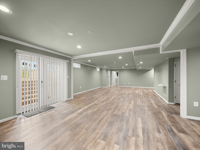 basement featuring crown molding, wood finished floors, baseboards, and recessed lighting