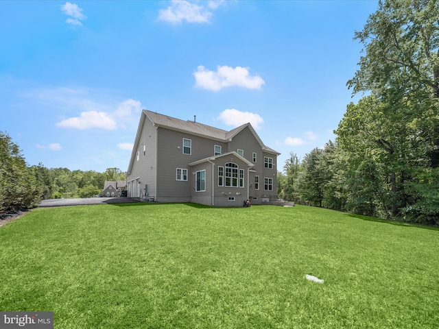 rear view of house with a yard