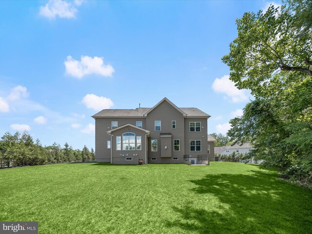 rear view of property with a lawn
