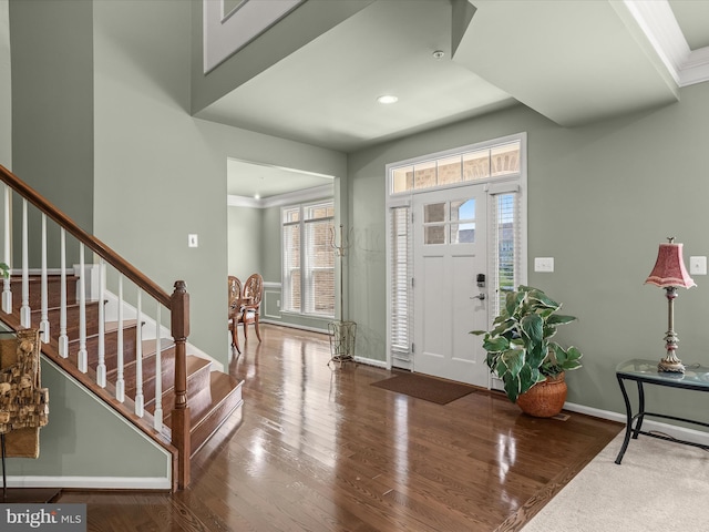 entryway featuring wood finished floors, baseboards, stairs, and recessed lighting