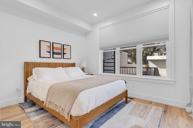 bedroom with recessed lighting, baseboards, and wood finished floors